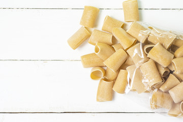 composition of raw Paccheri Pasta. Variety of Italian pasta in the shape of a very large tube. 