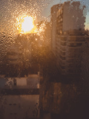 Blurred droplet on room windows and sun light abstract background