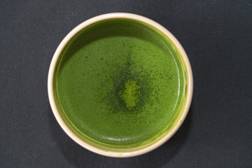 Top view of organic green matcha tea in a bow
