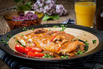 Potato pancakes with meat stew served on a plate.