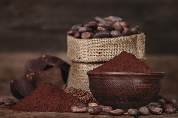 Cocoa powder in the bowl, chocolate and beans