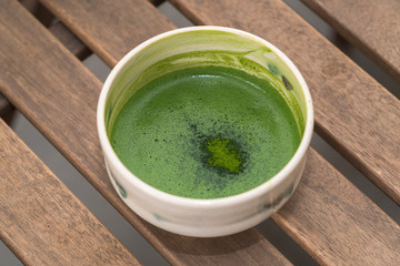 Fresh matcha tea on wooden background
