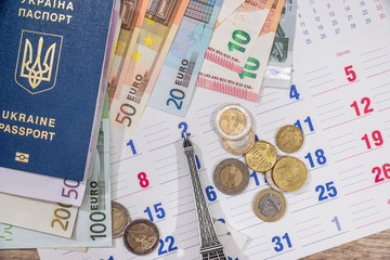 calendar, euro bills and coin with passport. travel concept.