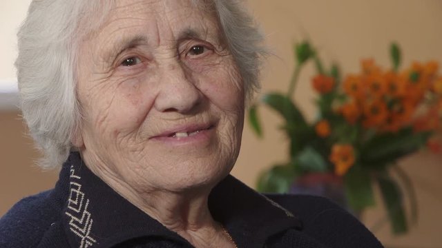 toothless elderly woman smiling happily to the camera