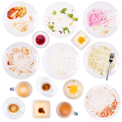 Dirty plates and cups after a meal isolated on white background © photka