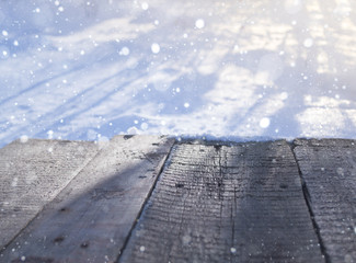 Board of wood in the winter in the snow with blurred background