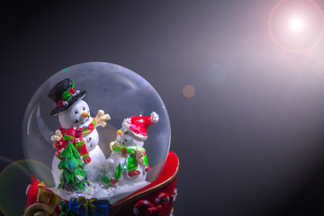 Christmas snow globe with snowman with len flare effect