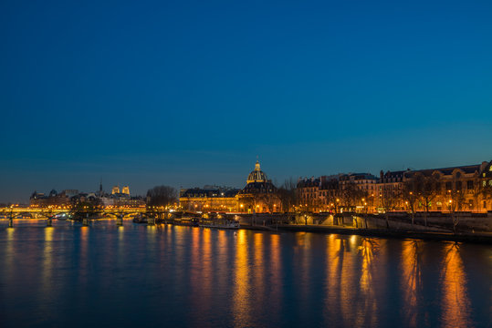 Fototapeta Bridge by the Seine river in Paris at night