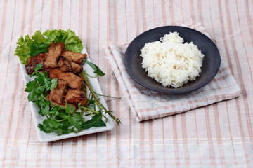 Grilled pork with mixed herb served sticky rice .