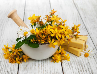 Tutsan flowers  and mortar with soap