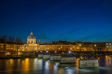 Pont des arts Bridge by the Seine river in Paris at night