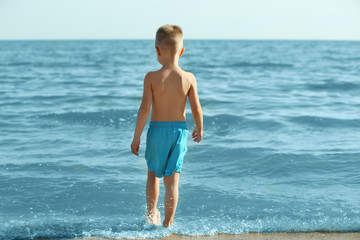 Cute boy having fun on beach