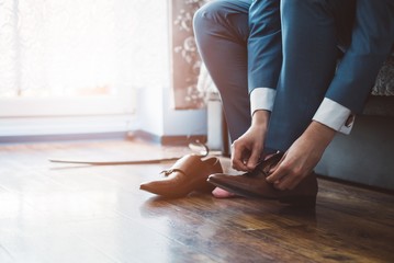 Groom dressing up with classic elegant shoes.