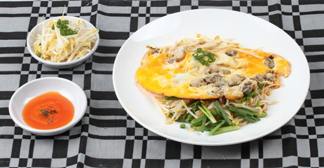 Oyster omelet with herb call Hoi Tod Khai in Thai .