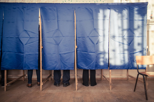 People vote in voting booth