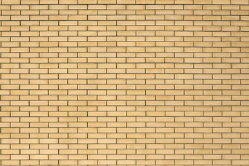 High resolution texture of a yellow brick wall. Laying horizonta