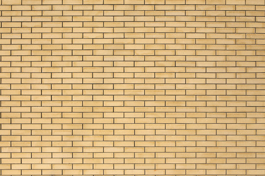 High resolution texture of a yellow brick wall. Laying horizonta