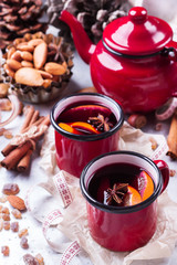Hot mulled wine in a red mug for winter holidays