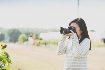 Beautiful Asian girl taking pictures