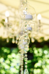Crystal chain hangs from the ceiling in green porch
