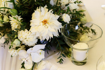 Large white flower hangs above bowl with sugar