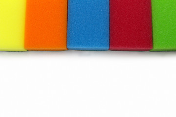 Multicolored sponges for washing dishes on a white background