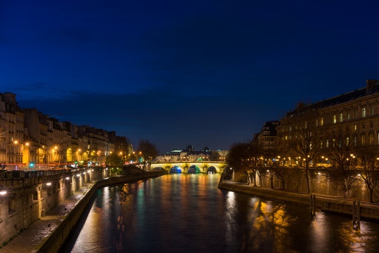 Bridge by the Seine river in Paris at night
