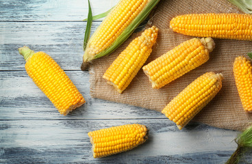 Corncobs with napkin on wooden white table