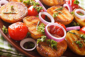 Grilled new potatoes and tomatoes macro on a plate. horizontal