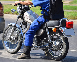 Man with a motorcycle on the street