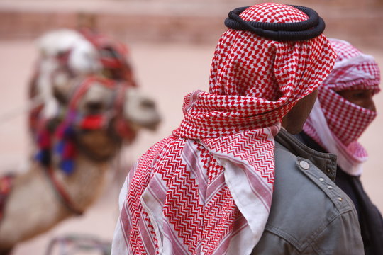 Camel drivers wearing traditionnal keffiyah scarves in Petra, Jordan