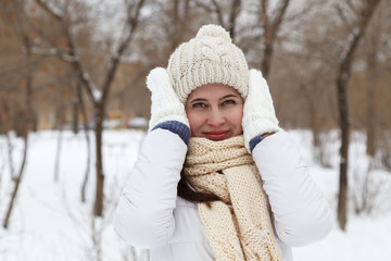 Fototapeta premium The girl in a winter white down-padded coat