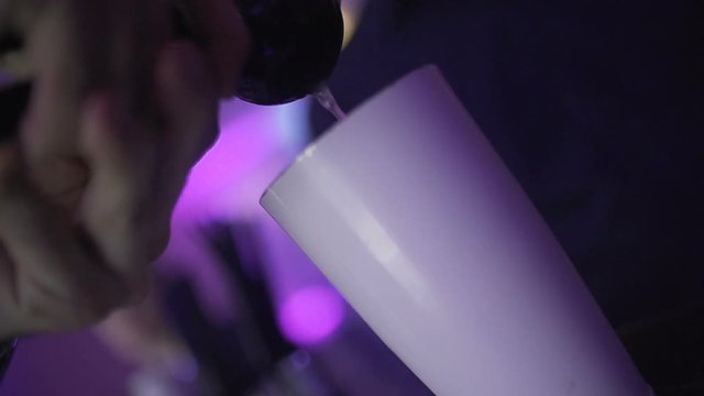 SLO MO CLOSE-UP Bartender preparing cocktail