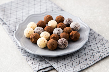 Assorted chocolate truffles with cocoa powder, coconut and chopp