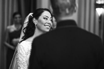 Look from behind groom's back at stunning bride