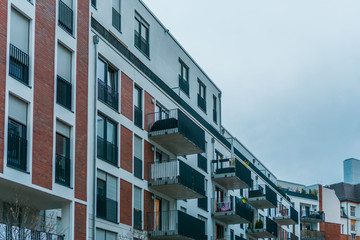 white and orange facaded apartment houses with steel balcony