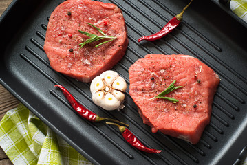 Raw beef steak on Grill pan.
