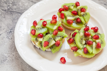 Christmas wreath donuts with kiwi and pomegranate