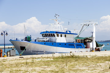 blue and white fishing boat at the pier, Greece