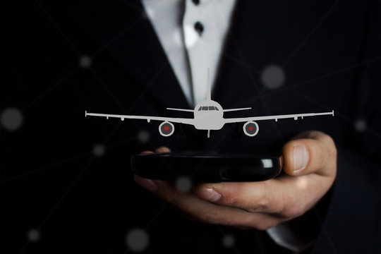 Businessman hand phone with airplane