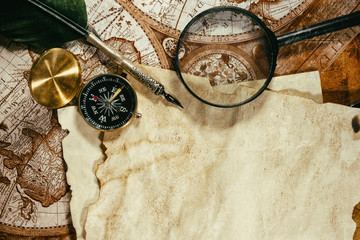 Vintage papers and maps with fountain pen, compass and magnifier