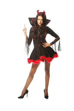 Portrait of a woman wearing devil clothes pointing up 