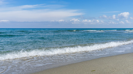 Fototapeta na wymiar View on Mediterranean Sea with sunny sand beach. Nei Pori village, Pieria, Greece. 
