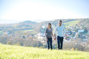 Couple walking in countryside on sunny fall day