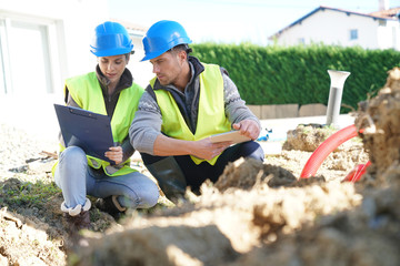 Construction site professional looking at digging in work