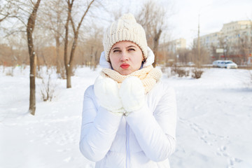 Fototapeta na wymiar The girl in a winter white down-padded coat