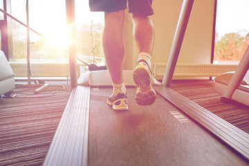 close up of man legs walking on treadmill in gym