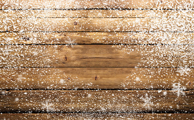 wooden background with snowflakes and snow