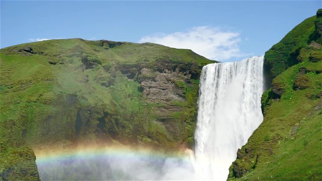Scenic view of famous Skogafoss waterfall in South Iceland. Footage of mighty Skogafoss waterfall with beautiful rainbow.