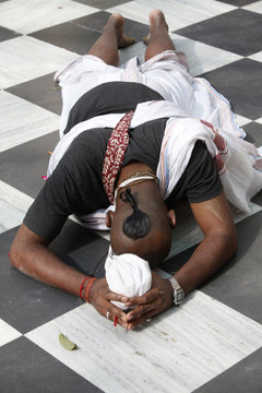 Hare Krishna devotee prostrating on the temple floor, Vrindavan, Uttar Pradesh 